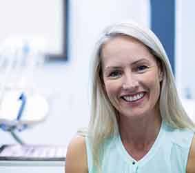 Smiling older woman in dentist’s office