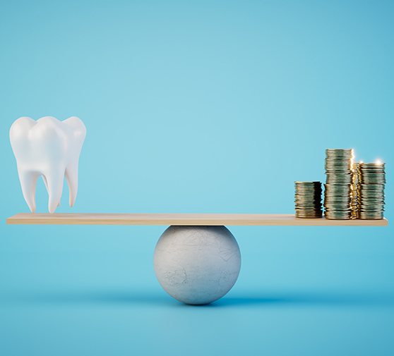 A balance beam on which a model tooth and coins are balanced