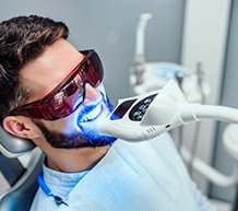 Young man undergoing in-office teeth whitening treatment